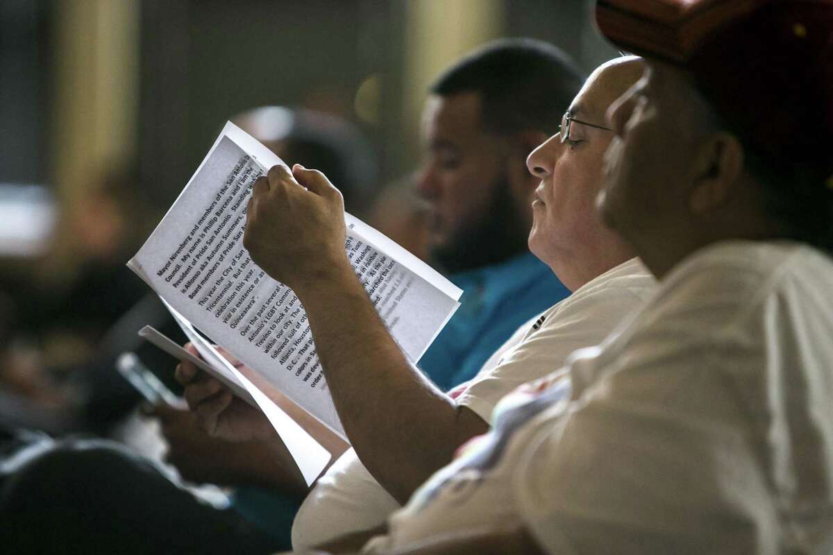 Phillip Barcena of Pride San Antonio looks over his notes before addressing the council in support of the croswalk.