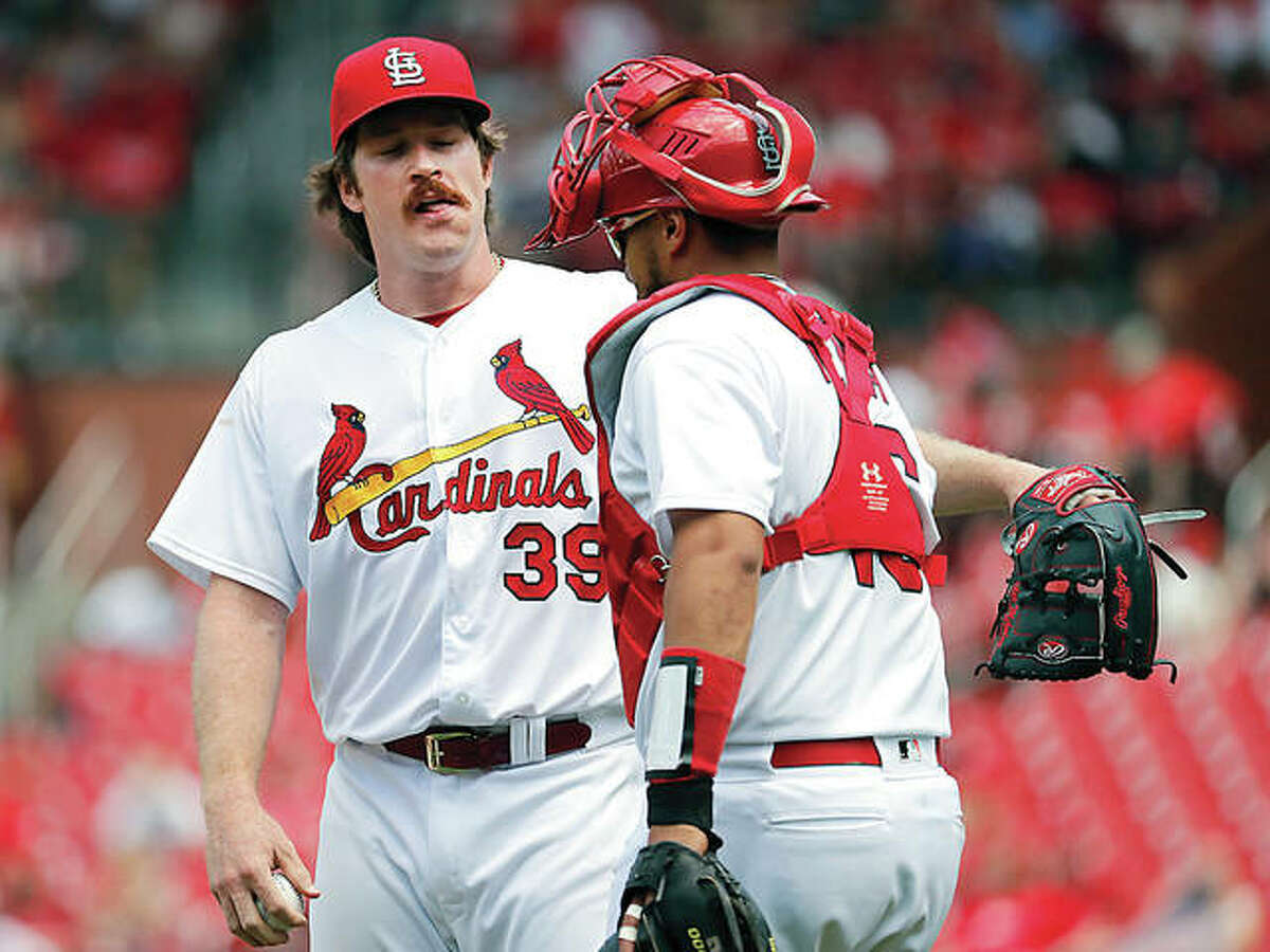Cardinals starting pitcher Miles Mikolas (39) talks with catcher Francisco Pena during the seventh inning of Thursday’s game against the Miami Marlins in St. Louis.
