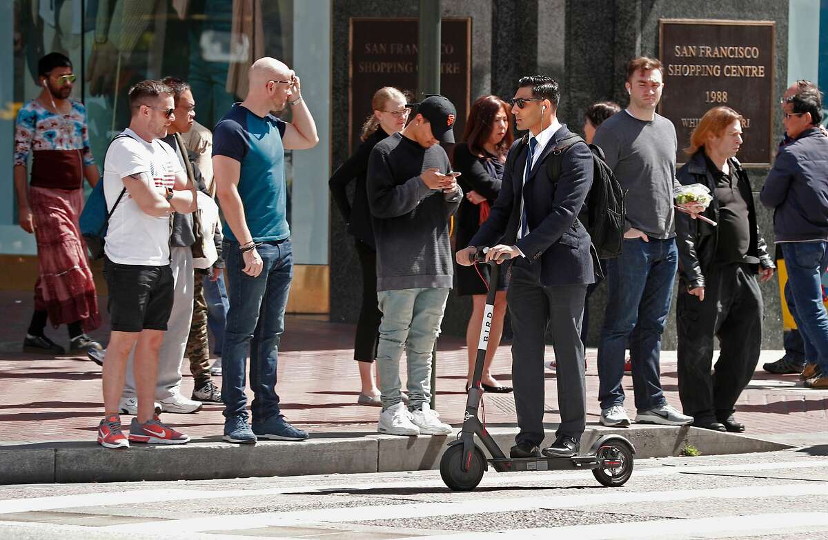 A man rides a Bird scooter along Market st. on Mon. April 9, 2018, in San Francisco, Calif.