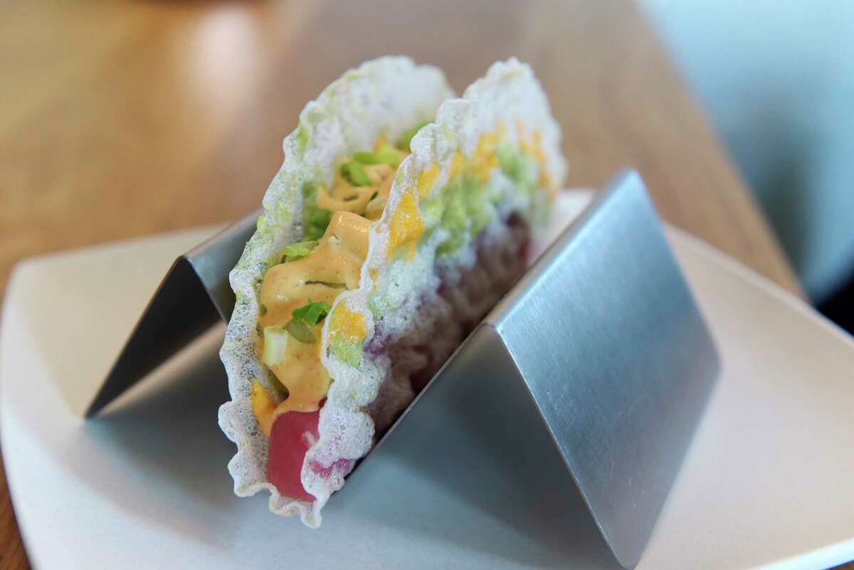 A view of Sashimi Taco, crispy fried rice paper filled with chef's choice. Pictured in this taco is ahi tuna, avocado, cucumber, spicy mayo, and scallions. Photographed at The Little Rice Ball, located at 6 Franklin Place, on Wednesday, May 30, 2018, in Troy, N.Y. (Paul Buckowski/Times Union)
