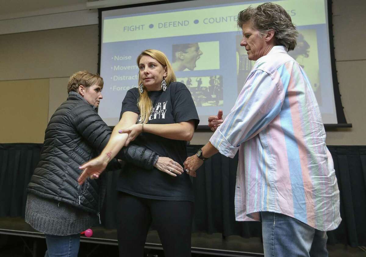 Sasha McLean, center, Executive Director for Archway Academy, demonstrates to attack an armed shooter with number of people during her active shooter training session at the Student Safety and Discipline Institute at the Harris County Department of Education building on Wednesday, June 6, 2018, in Houston. McLean was performing as the shooter while Ana Valerio, left, and Shari Matteson trying to take her doww with their body. Valerio is a school nurse at Wilson Montessori and Matteson is a teacher at James H. Baker Sixth Grade Campus in La Porte. McLean taught how to actively respond to an active shooter situation to school officials from across the Houston area. ( Yi-Chin Lee / Houston Chronicle )