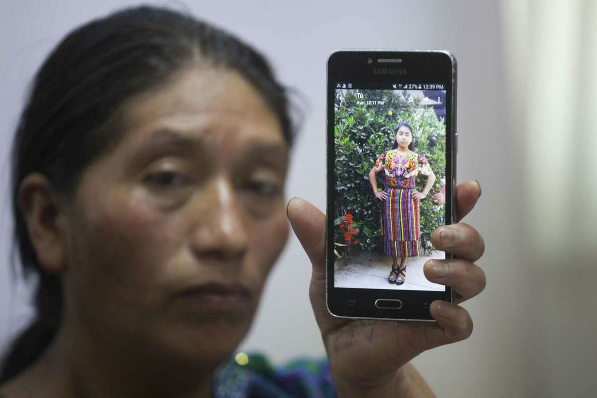 Dominga Vicente shows a photo of her niece, 20 year-old Claudia Patricia Gomez Gonzalez, who was allegedly killed by an agent of the U.S. Border Patrol in Nuevo Laredo, Texas, on Wednesday, during a press conference at the National Migrants Commission headquarters in Guatemala City, Friday, May 25, 2018. The family of Gomez Gonzalez, of the Mam indigenous community and natives of San Juan Ostuncalco, Guatemala, are asking for justice in her death. (AP Photo/Moises Castillo)