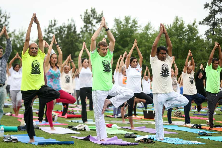 The Woodlands celebration of International Yoga Day is set for June 23. In this Villager file photo, attendees of the 2017 International Yoga Day celebration, hosted by The Hindu Temple of The Woodlands, take part in meditation and yoga on June 24 at Town Green Park. Photo: Michael Minasi, Staff Photographer / Houston Chronicle / Â© 2017 Houston Chronicle