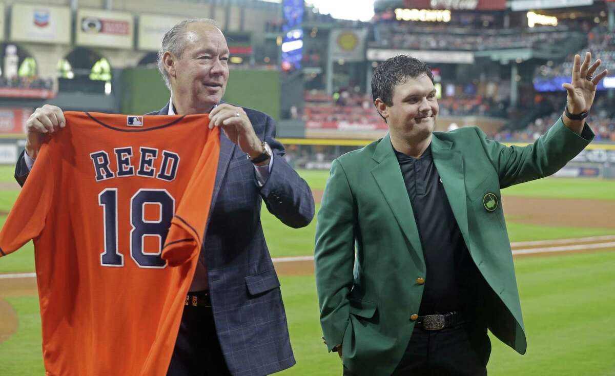 Houston Astros owner Jim Crane presents Masters winner, Patrick Reed, with a jersey during pre-game ceremonies at Minute Maid Park Saturday, April 14, 2018, in Houston.