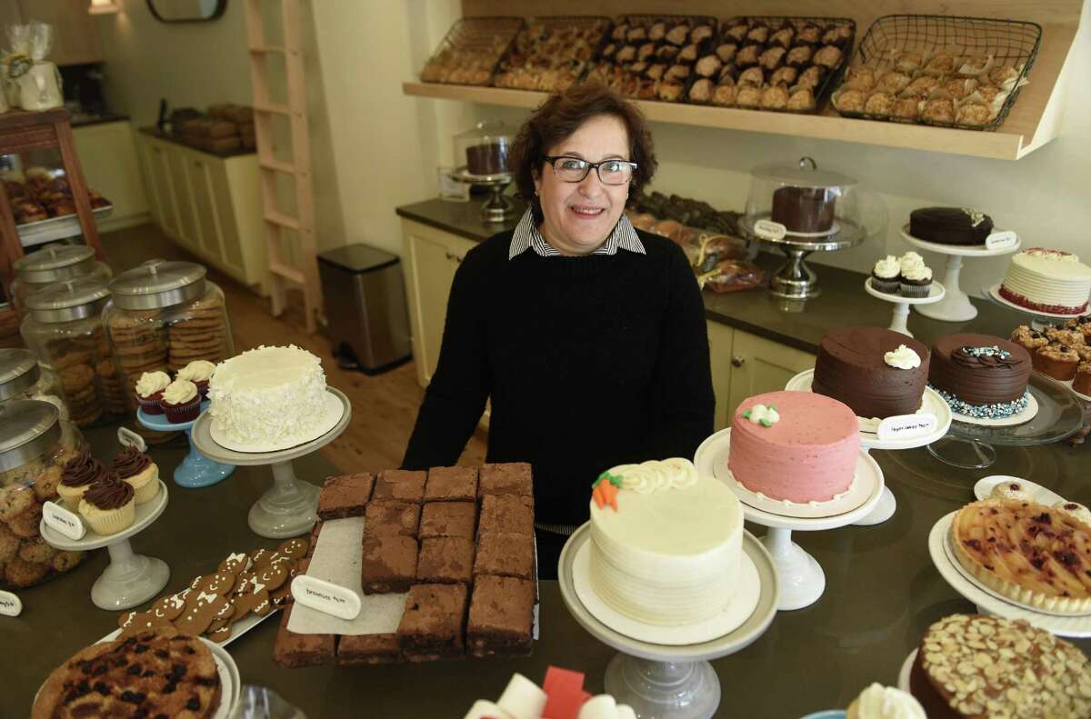 Owner Helene Godin poses behind the counter at By the Way Bakery in Greenwich, Conn. Wednesday, Dec. 21, 2016. Located at 19 E. Putnam Ave., the bakery serves a variety of pastries, cakes and other baked goods.
