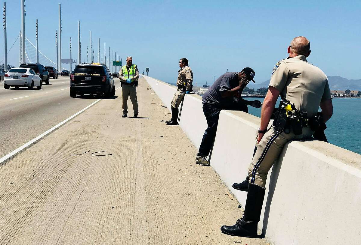 A California Highway Patrol- San Francisco officer speaks to a man on the ledge of the Bay Bridge.