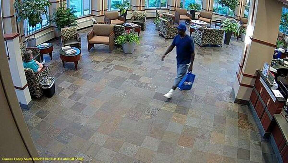 A suspect, center, allegedly involved in a theft of an AMH patient’s belongings is described as a heavy set, middle-aged black male wearing a blue New York Mets baseball cap, blue short sleeve shirt, blue jean shorts, and white shoes.