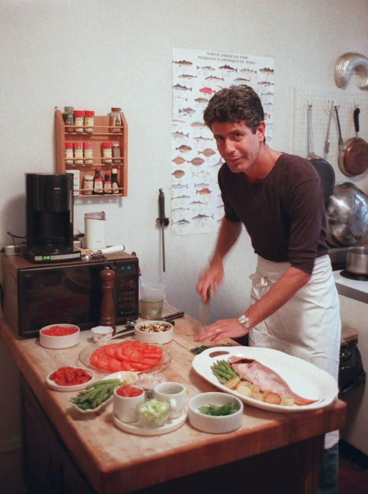 Anthony Bourdain prepared a meal in the kitchen of his New York apartment in 1997. Bourdain, a travel host whose memoir ?“Kitchen Confidential?” about the dark corners of New York?’s restaurants started a career in television, died on Friday. He was 61. (Jack Manning/The New York Times)