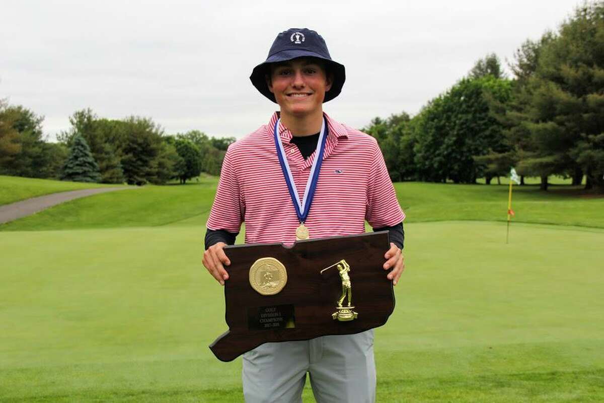 Jackson Fretty holds the championship trophy after the Greenwich High School boys golf team won the CIAC Division I title on Monday at Stanley Golf Club in New Britain. Fretty earned medalist honors at the tournament with a 3-under-par 68