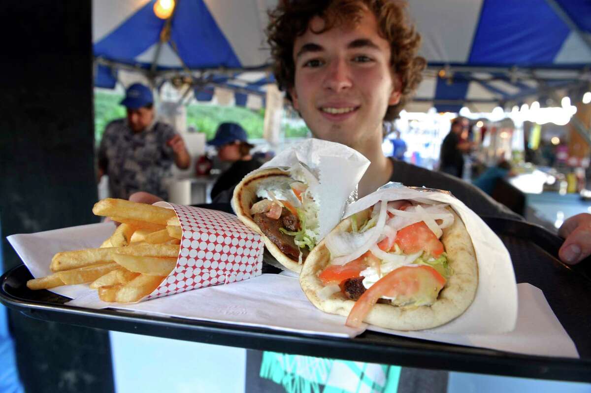 Nicholas Thiel-Hudson, of New Fairfield, holds up a tray of gyros at the annual Assumption Greek Experience Festival, Friday, June 8, 2018, in Danbury, Conn. 