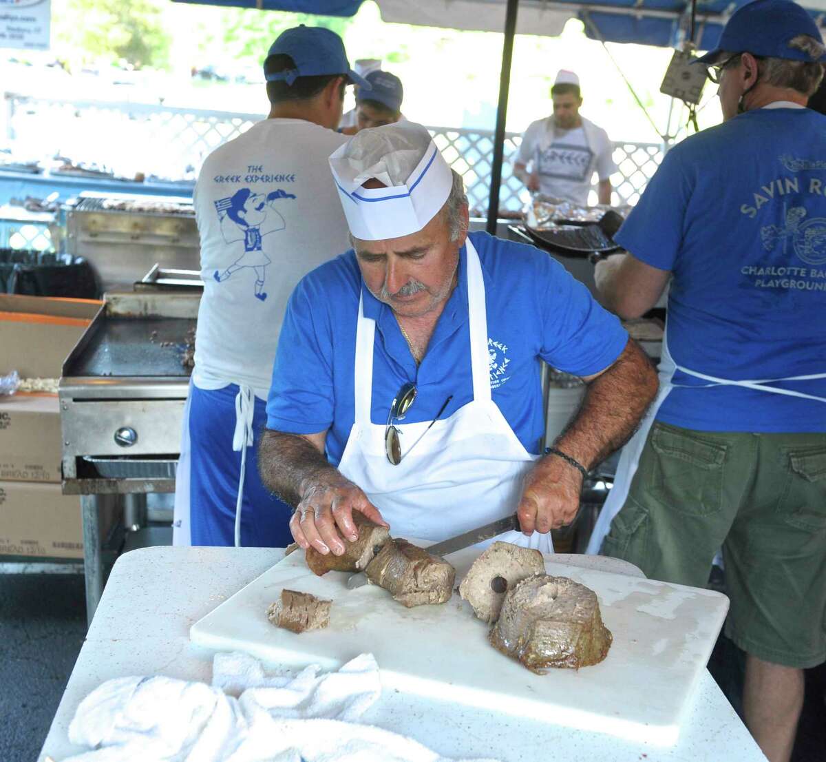 Spiro Rountos, of Danbury, cuts meat for gyros during the annual Assumption Greek Experience Festival, Friday, June 8, 2018, in Danbury, Conn. 