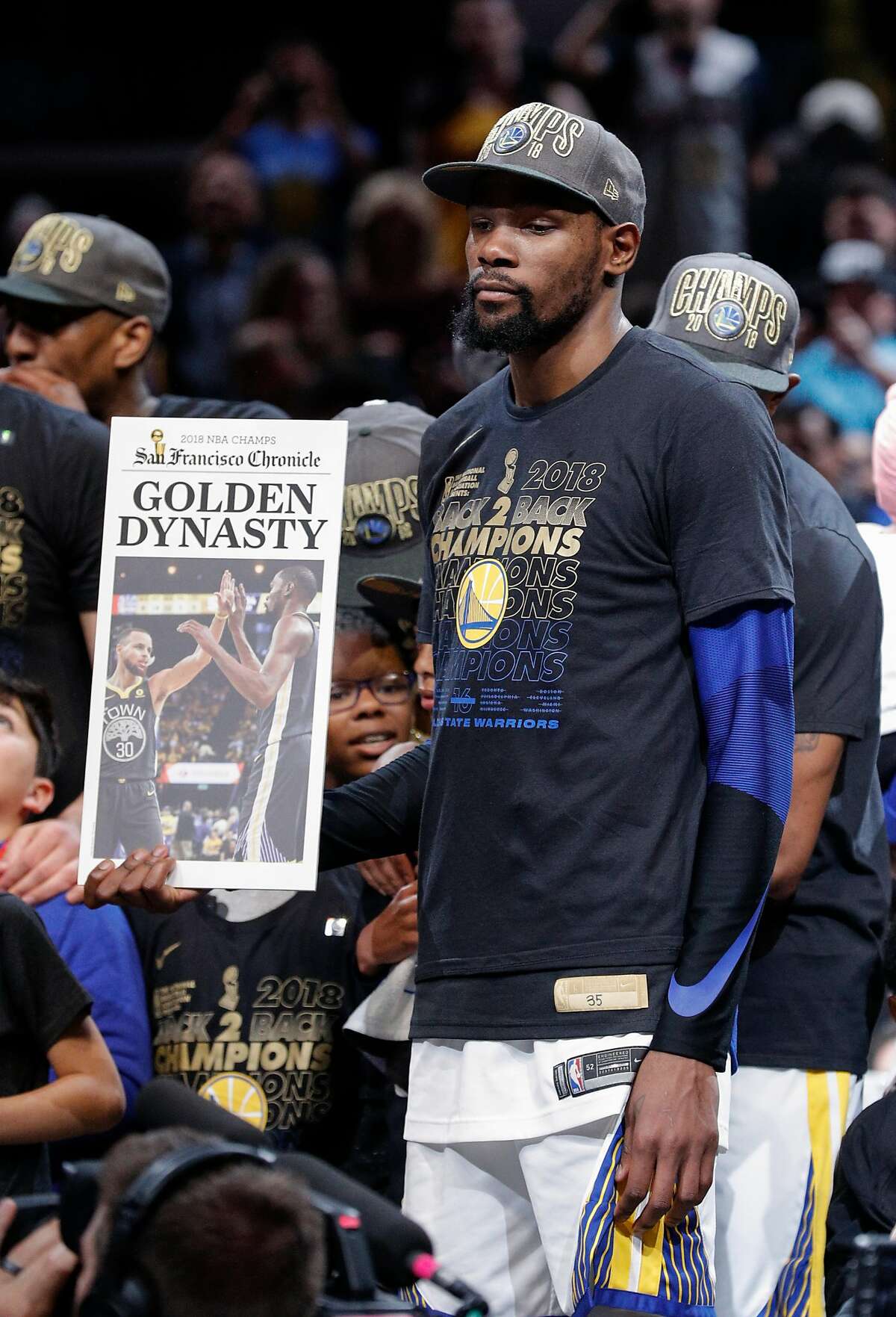 The Golden State Warriors' Kevin Durant holds up a Chronicle front page after their 108 to 85 victory over the Cleveland Cavaliers in game 4 of The NBA Finals between the Golden State Warriors and the Cleveland Cavaliers at Oracle Arena on Friday, June 8, 2018 in Cleveland, Ohio.