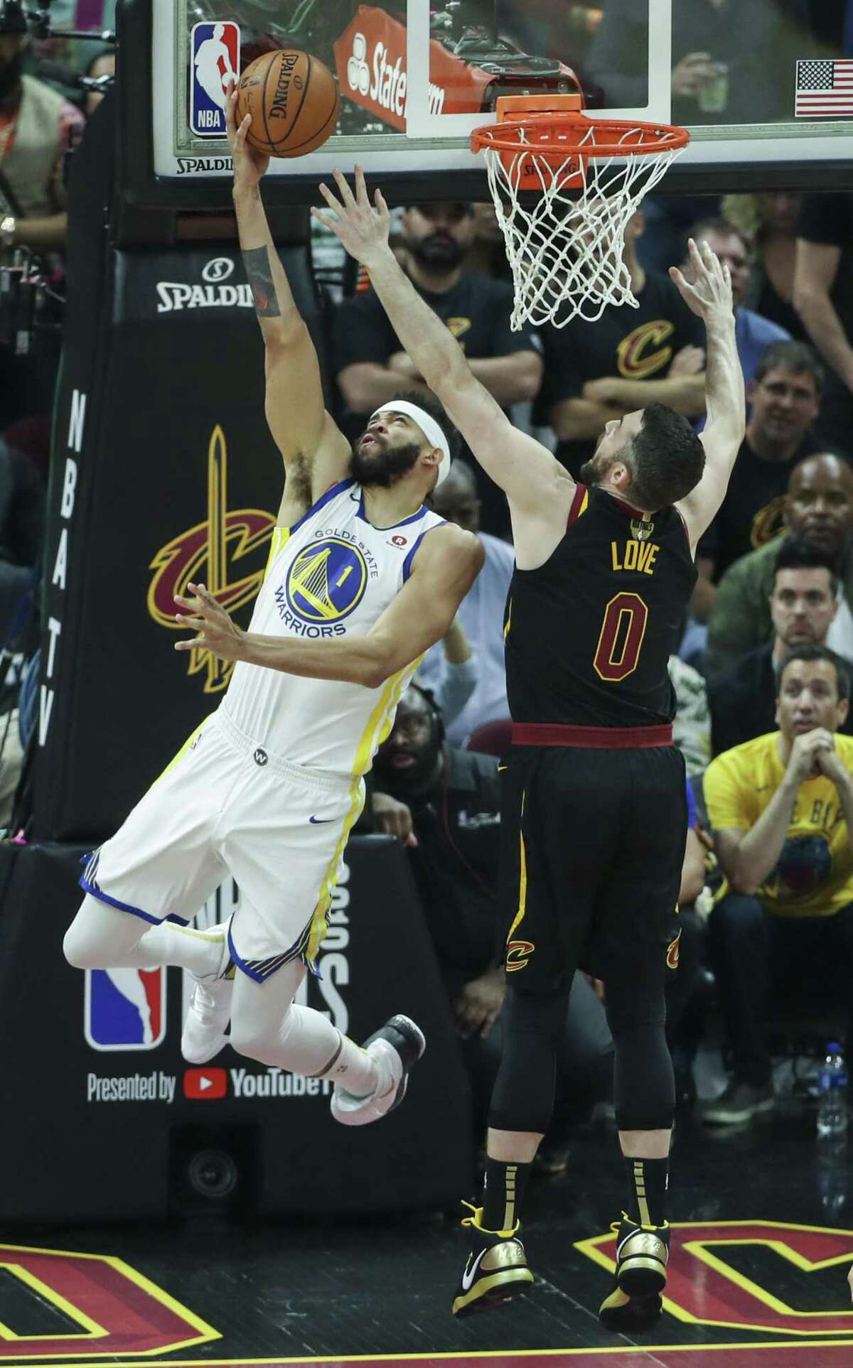 Golden State Warriors' JaVale McGee goes up for a reverse layup agaisnt Cleveland Cavaliers' Kevin Love in the first quarter during game 4 of The NBA Finals between the Golden State Warriors and the Cleveland Cavaliers at Oracle Arena on Friday, June 8, 2018 in Cleveland, Ohio.