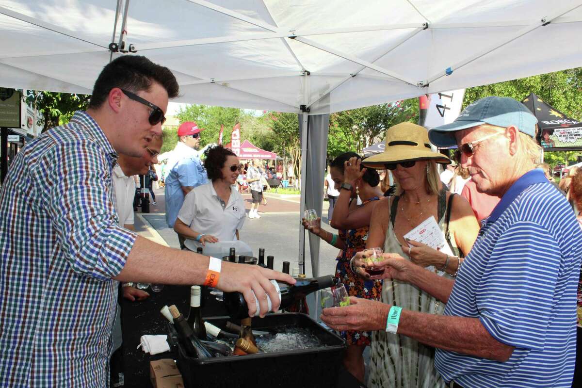 Ryan Partridge, with Jackson Family Wines, discusses the various wines his company offers while pouring a Cabernet Sauvignon for one of the many guests at the H-E-B Wine Walk at Market Street on Thursday, June 7, 2018. This year’s Wine Walk is set for Oct. 21.