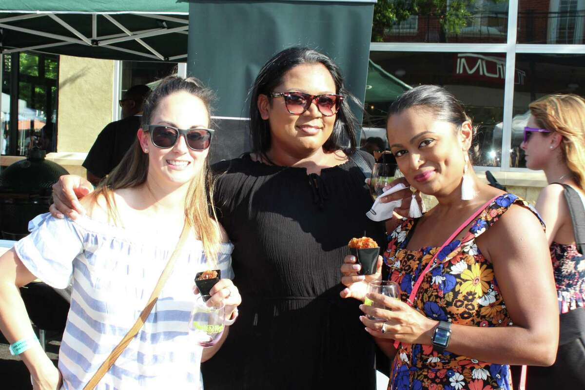 Attendees enjoy a variety of wine and food at the H-E-B Wine Walk at Market Street on June 7, 2018.