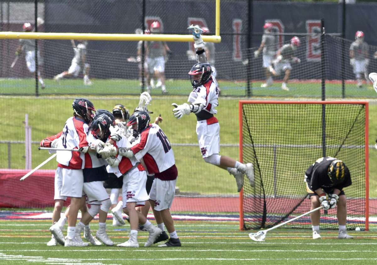 New Fairfield players celebrate the final goal of the game which put New Fairfield up 13 to 11 to defeat Daniel Hand High School in the boys lacrosse Class M State Championship, Saturday, June 9, 2018, at Brien McMahon High School, Norwalk, Conn.