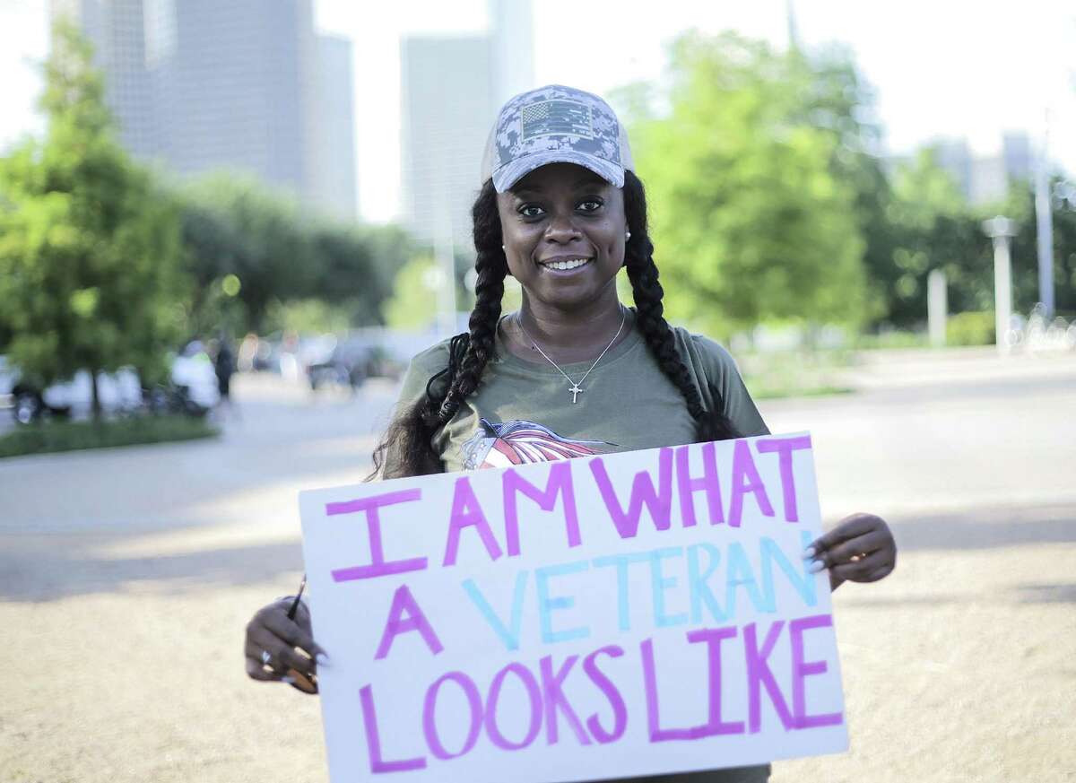 Army veteran Christy Chatham, holds a sign before marking to city hall with other women veterans on Saturday, June 9, 2018 in Houston. The veterans marched to celebrate progress and speak out for against abuse and challenges they face. (Elizabeth Conley/Houston Chronicle)