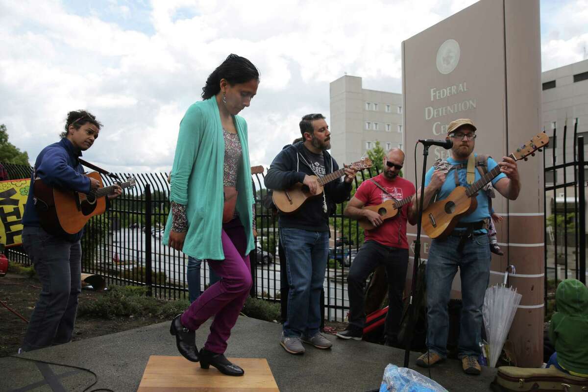 Seattle Fandango Project performs as several hundred protesters and elected officials including Washington State Governor Jay Inslee, State Attorney General Bob Ferguson and U.S. Rep. Pramila Jayapal (D-Seattle), gather at the Federal Detention Center in SeaTac where 174 women are being held, most of whom fled Central America to seek political asylum in the U.S., June 9, 2018. According to Jayapal, who met with the women Saturday, many said their children were taken from them after they crossed the border into Texas. The protest included speeches, sign making, letter writing, and music.