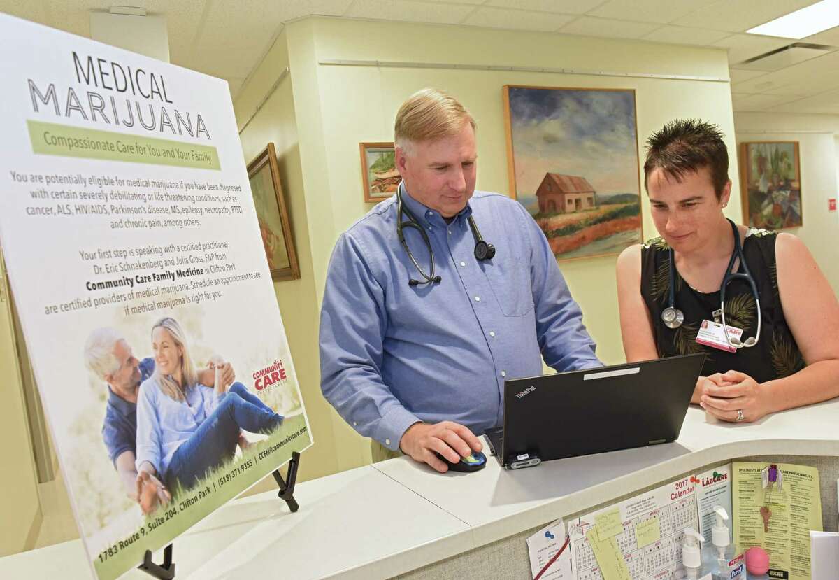 Dr. Eric Schnakenberg, a physician at Community Care Family Medicine in Clifton Park, and his colleague, Julia Gross, a nurse practitioner stand in their facility on Thursday, June 8, 2018 in Clifton Park, N.Y. They are among a small but growing number of practitioners in New York who have found success weaning patients off of opioids and onto medical marijuana for their chronic pain. (Lori Van Buren/Times Union)
