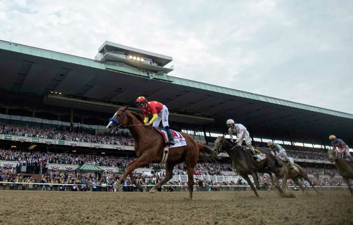 Justify with jockey Mike Smith wins the 150th running of the Belmont Stakes and the coveted Triple Crown of Thoroughbred race at Belmont Park Saturday June 9, 2018, in Elmont, N.Y. (Skip Dickstein/Times Union)
