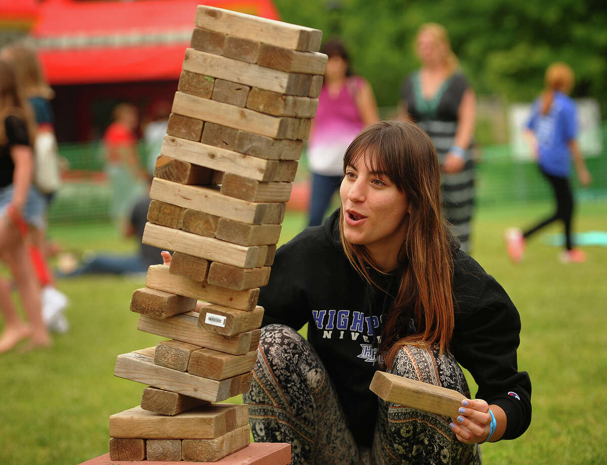 Nina Zovko, of Montclair, NJ, tries her hand at a game of Jenga at the Riverfront Music Festival in Shelton, Conn. on Sunday, June 10, 2018.
