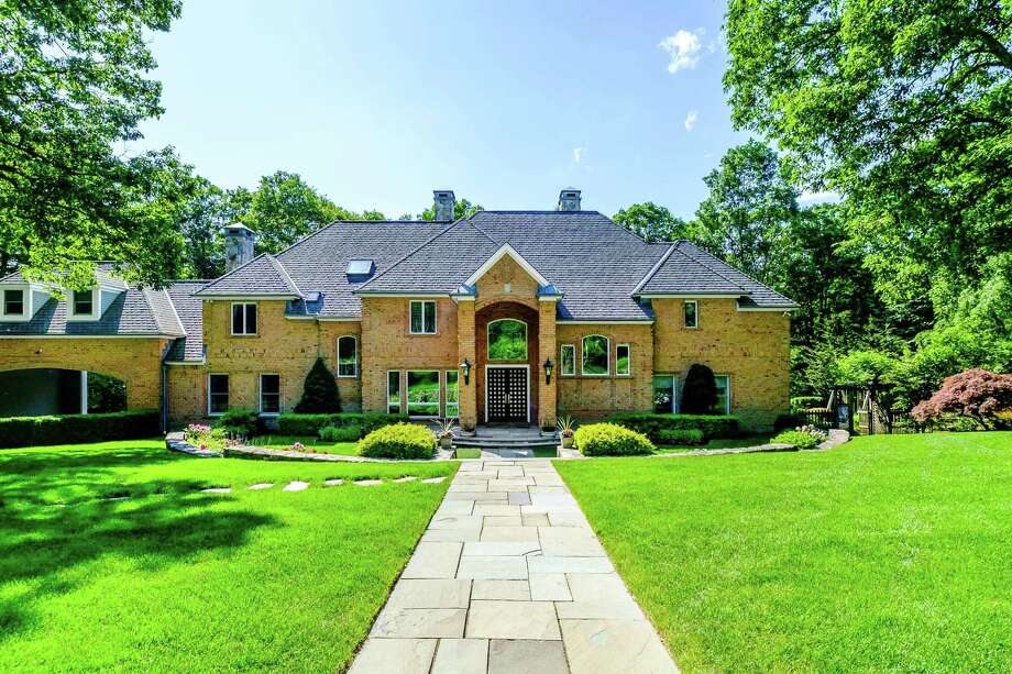 The red brick colonial house at 45 Aspetuck Falls is located on a private cul-de-sac in the Greenfield Hill neighborhood. Photo: Nathan Spotts And/or Lauren Kinkade / © Nathan Spotts & Lauren Kinkade