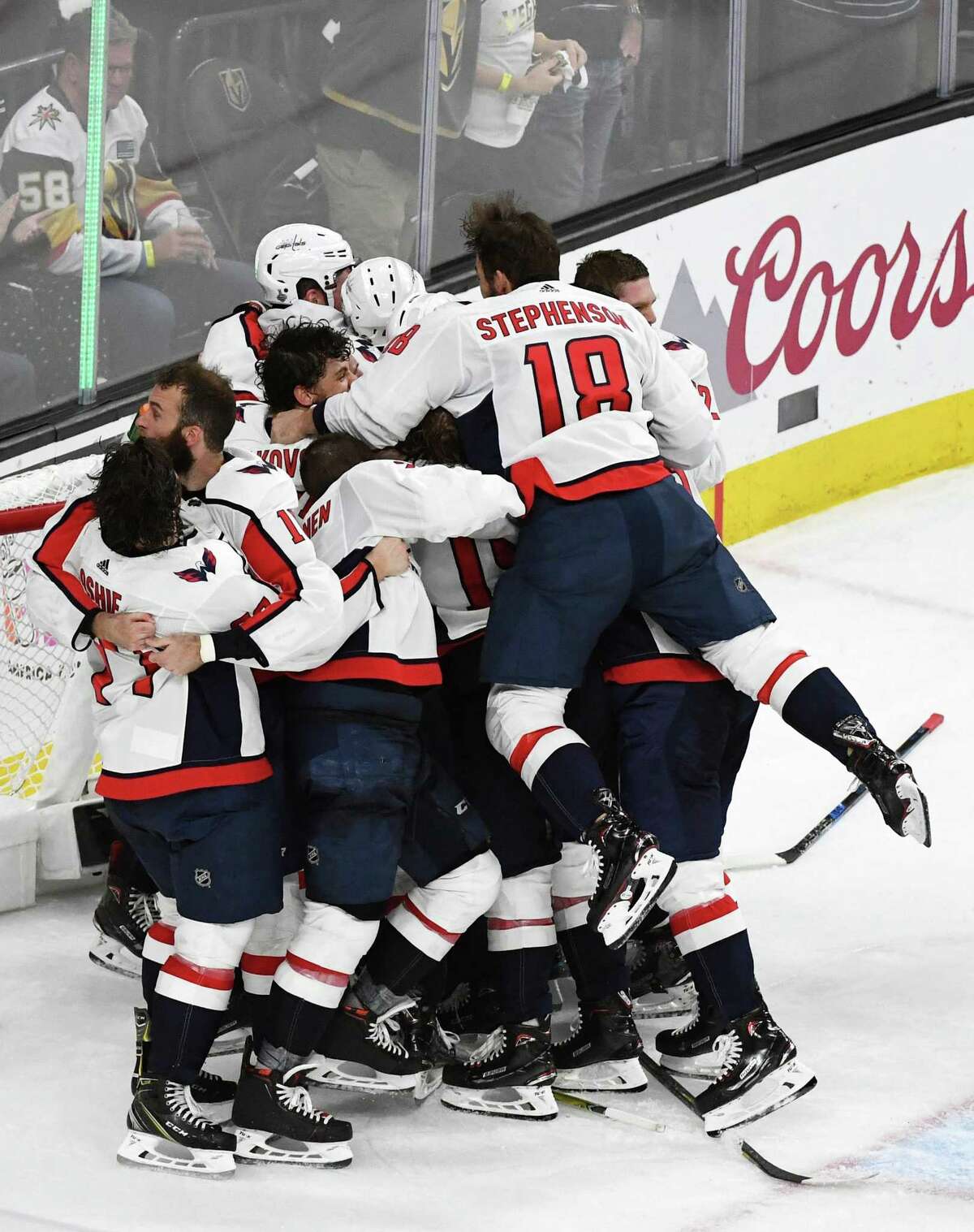 LAS VEGAS, NV - JUNE 07: Chandler Stephenson, No. 18, of the Washington Capitals leaps into his teammates’ arms, as they celebrate their 4-3 win over the Vegas Golden Knights in Game 5 of the 2018 NHL Stanley Cup Final, at T-Mobile Arena, on June 7, 2018, in Las Vegas, Nevada.