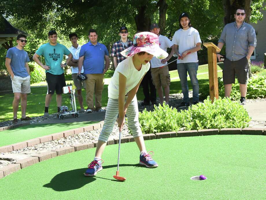 Gracie Keat, age 6, makes a putt as she plays miniature golf at Pirate's Cove on Monday, June 11, 2018 in Waterford, N.Y. She was competing against robots controlled and made by Union College students. The students are in her father Professor Bill Keat's mechanical design class. (Lori Van Buren/Times Union) Photo: Lori Van Buren, Albany Times Union / 40044042A