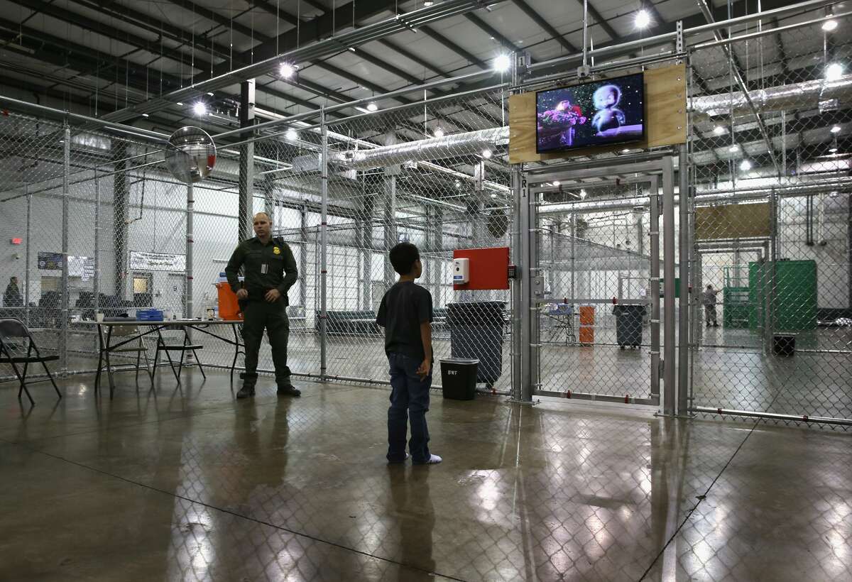 A boy from Honduras watches a movie at a detention facility run by the U.S. Border Patrol on September 8, 2014 in McAllen, Texas. See how the U.S.-Mexico border wall has changed over the years.
