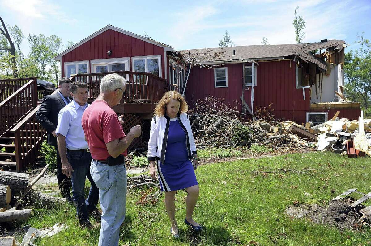 Brookfield Selectman Harry Shaker and U.S.Rep. Elizabeth Esty speak with homeowner Raymond Murphy whose home was heavily damaged by last month's macroburst. The Federal Emergency Management Agency, Brookfield officials and U.S. Rep. Elizabeth Esty toured areas of Brookfield Monday, June 11, 2018, most heavily damaged.