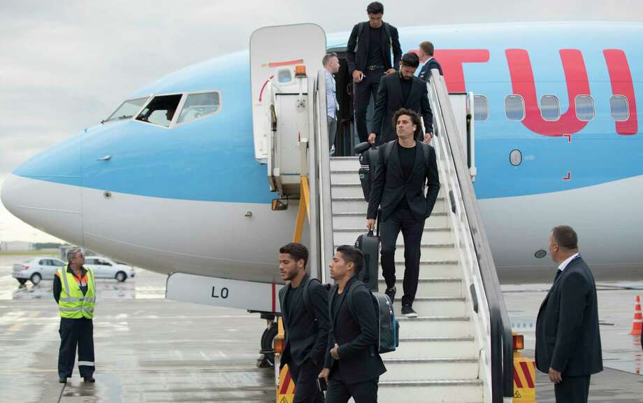 Guillermo Ochoa, center, and his teammates disembark the plane as the Mexico national soccer team arrive at the Sheremetyevo international airport, outside Moscow, Russia, Monday, June 11, 2018, to compete in the 2018 World Cup in Russia. The 21st World Cup begins on Thursday, June 14, 2018, when host Russia takes on Saudi Arabia. (AP Photo/Pavel Golovkin) Photo: Pavel Golovkin / Copyright 2018 The Associated Press. All rights reserved.