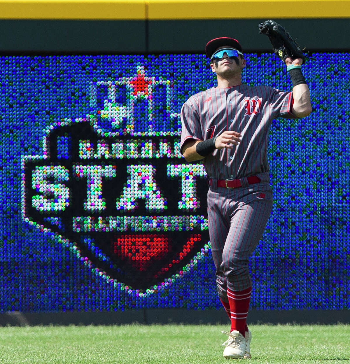 The Woodlands left fielder Zayne Watson (7) fields a fly ball by Nik Millsap #32 of Southlake Carroll in the first inning of a Class 6A state semifinal game during the UIL State Baseball Championships at Dell Diamond on Friday, June 8, 2018, in Round Rock.