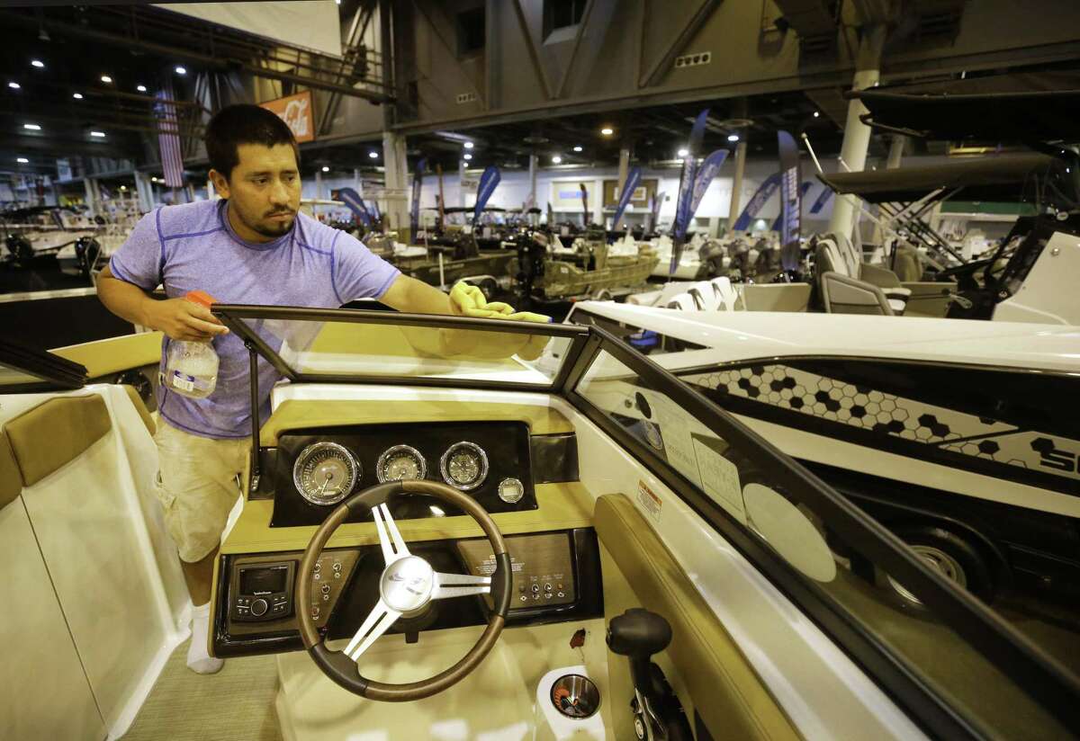 Henry Garcia works to clean a 23 foot Sea Ray boat Monday, June 11, 2018, in Houston in the Marine Max area for the Houston Summer Boat Show that opens June 13 through June 17 at NRG Center. ( Melissa Phillip / Houston Chronicle )