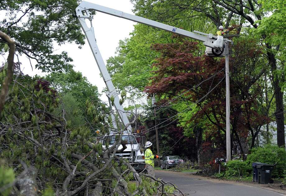 An Eversouce crew from Colorado - Clark Kent on the ground and Bruce Wayne above - work to restore power on Allen Road in Brookfield Tuesday, May 22, 2018. Photo: Carol Kaliff / Hearst Connecticut Media / The News-Times