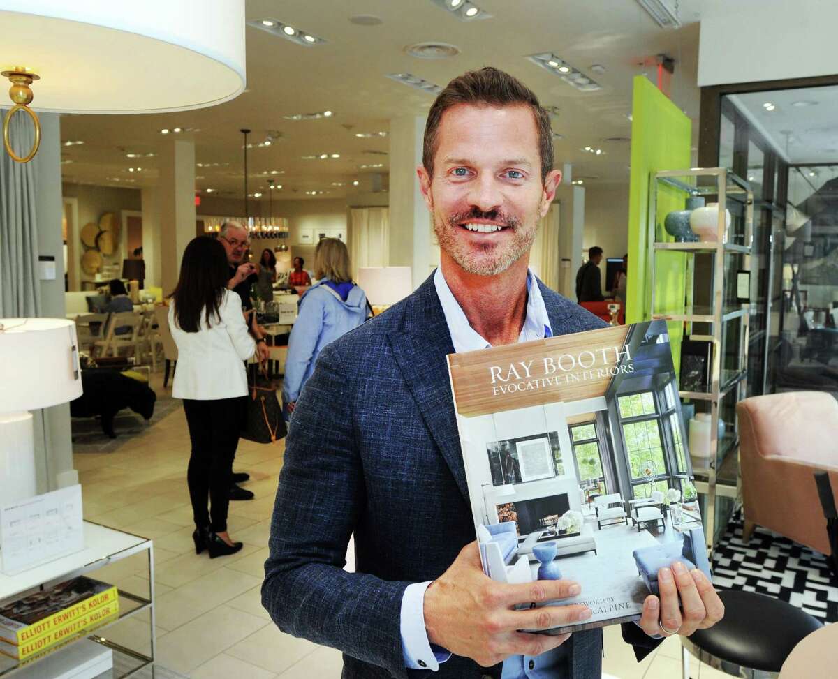 Interior designer Ray Booth of the design firm McALPINE with his book “Evocative Interiors,” at the Mitchell Gold + Bob Williams store during the Greenwich Design District’s Day of Design on Tuesday.
