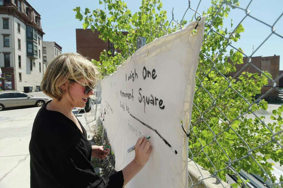 Liz Comitale, manager of Troy Farmers Market, writes farmer's market on a piece of fabric at the 1 Monument Square site on Tuesday, June 12, 2018, in Troy, N.Y. The fabric is hanging at the site for people to write their ideas on what they would like to see built at the site.   (Paul Buckowski/Times Union) Photo: Paul Buckowski, Albany Times Union / (Paul Buckowski/Times Union)