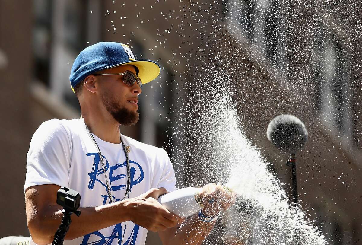 Stephen Curry of the Golden State Warriors sprays champagne during the Golden State Warriors Victory Parade on June 12, 2018 in Oakland.