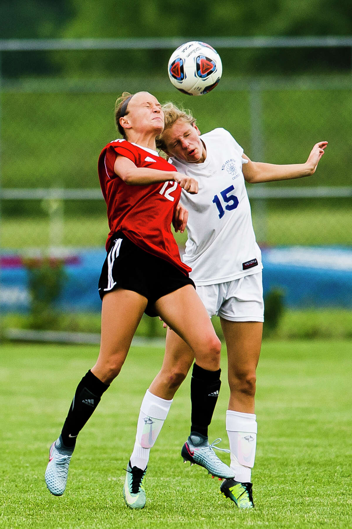 Midland junior Samantha Vansumeren jumps up for a header during the Chemics' 1-0 Division 1 semifinal loss to Grand Blanc on Tuesday, June 12, 2018 at Holt High School. (Katy Kildee/kkildee@mdn.net)