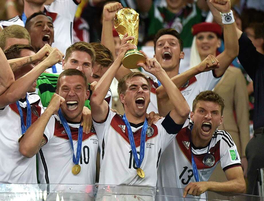 FILE - In this July 13, 2014, file photo, Germany's Philipp Lahm (16) raises the trophy after the World Cup final soccer match between Germany and Argentina at the Maracana Stadium in Rio de Janeiro, Brazil. After raising the World Cup eight miles from Copacabana Beach four years ago, Germany hopes to lift the trophy four miles from the Kremlin on July 15 and become the first repeat champion in more than a half-century.  (AP Photo/Martin Meissner, File) Photo: Martin Meissner / Copyright 2018 The Associated Press. All rights reserved.