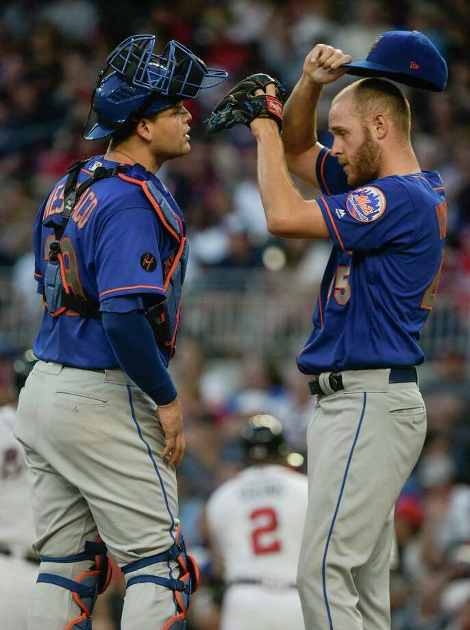 New York Mets catcher Devin Mesoraco, left, talks to pitcher Zack Wheeler, who had loaded the bases during the fourth inning of the team's baseball game against the Atlanta Braves, Tuesday, June 12, 2018, in Atlanta. (AP Photo/John Amis) Photo: John Amis / FR69715 AP