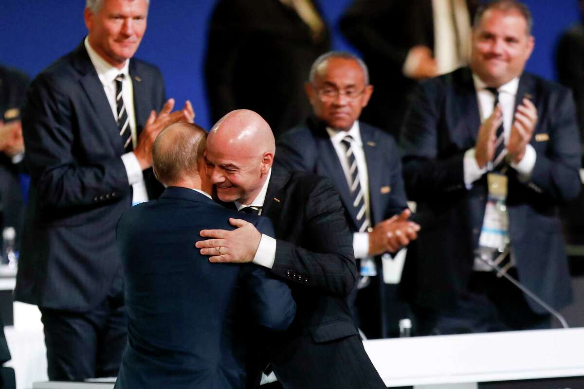 FIFA President Gianni Infantino, right, hugs Russian President Vladimir Putin at the FIFA congress on the eve of the opener of the 2018 soccer World Cup in Moscow, Russia, Wednesday, June 13, 2018. The congress in Moscow is set to choose the host or hosts for the 2026 World Cup.