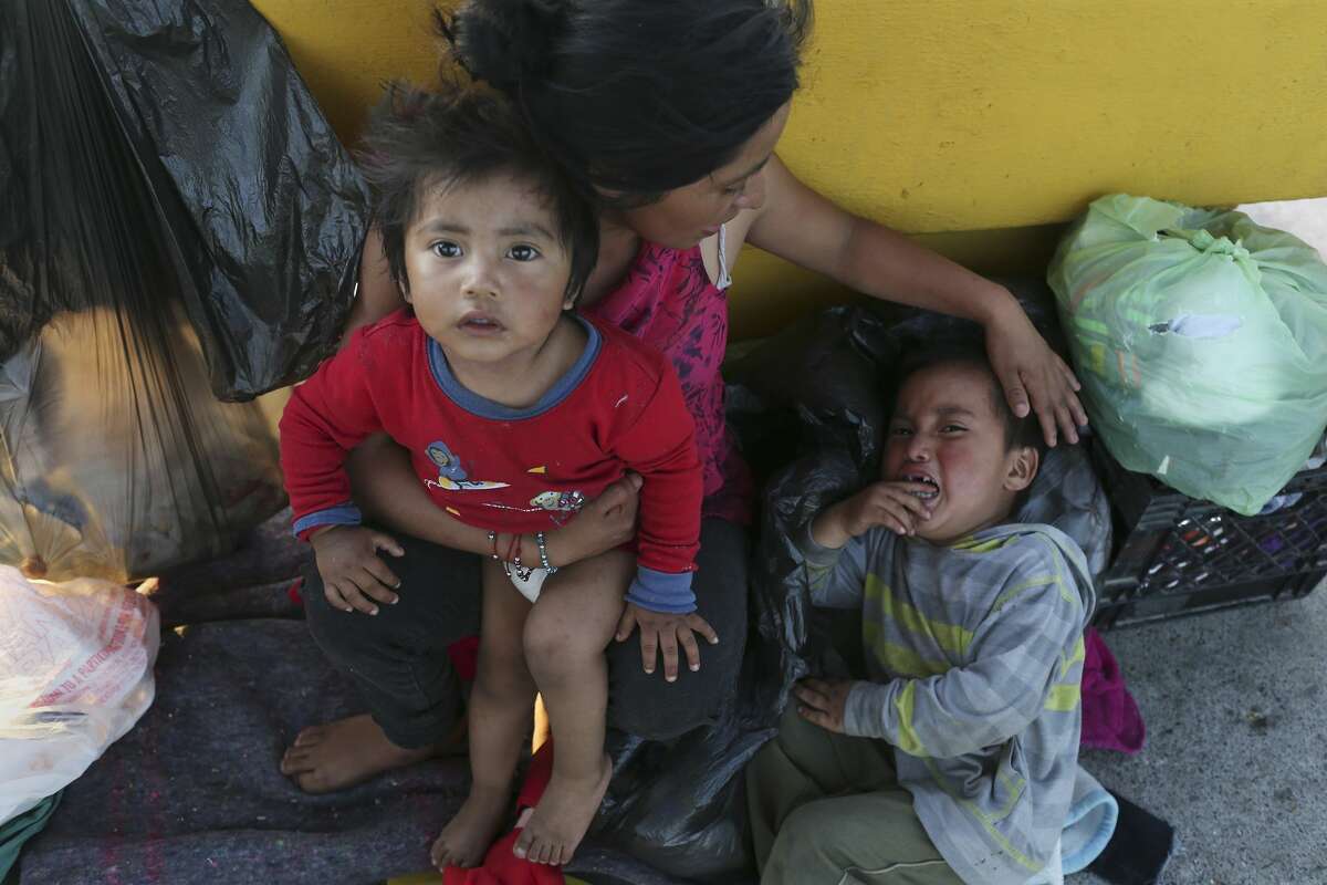 Antonia Florinda Lopez Ixmata, 20, sits with her children, Erik Lopez, 2, and Aymer Damian Lopez, 4, on the Mexican side of the Roma-Ciudad Miguel Aleman International Bridge by Roma, Texas, Tuesday, June 5, 2018. They are Mayan descendants from Guatemala and have been waiting on the bridge for 8 days hoping for asylum in the United States. Amid this new era of a "zero-tolerance" policy toward immigrants in the U. S., those seeking asylum through the United States' legal ports of entry --namely, the international bridges--are being denied entry. They've been told by agents that Department of Homeland Security facilities are overwhelmed.