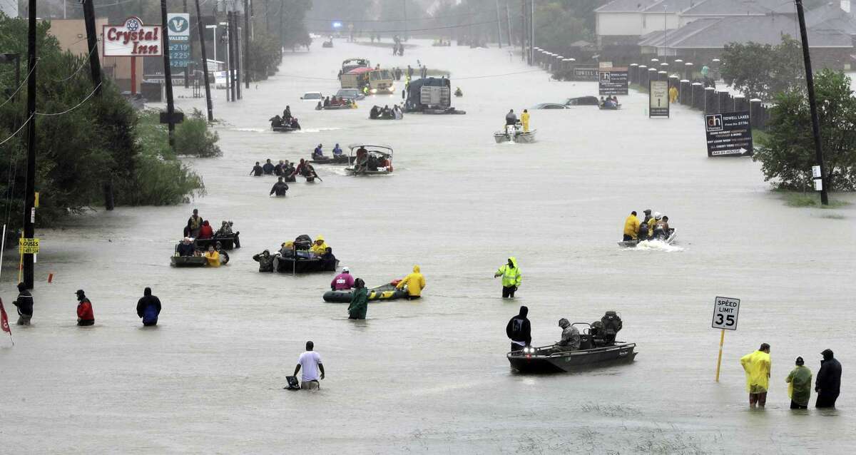 Rescue boats fill a flooded street as flood victims of Hurricane Harvey are evacuated in Aug. 2017.