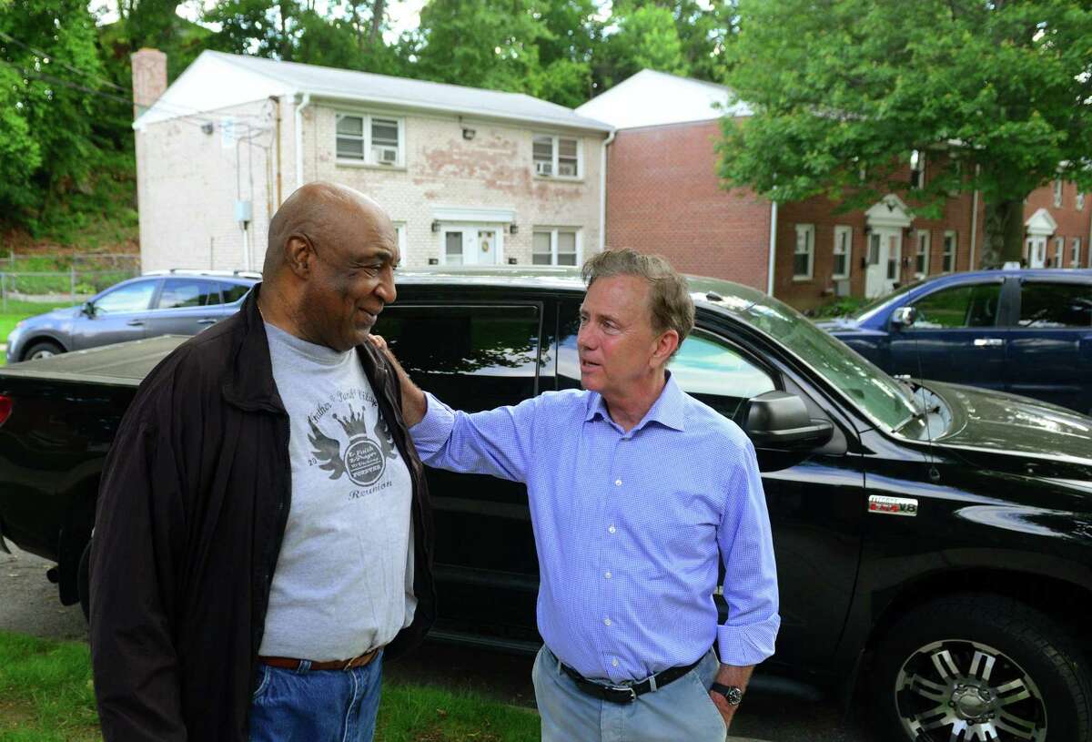 Ned Lamont, right, chats with Willie Murphy, a resident of the Second Stoneridge co-op, during a campaign stop at the co-op on Yaremich Drive in Bridgeport, Conn., on Tuesday, June 5, 2018.