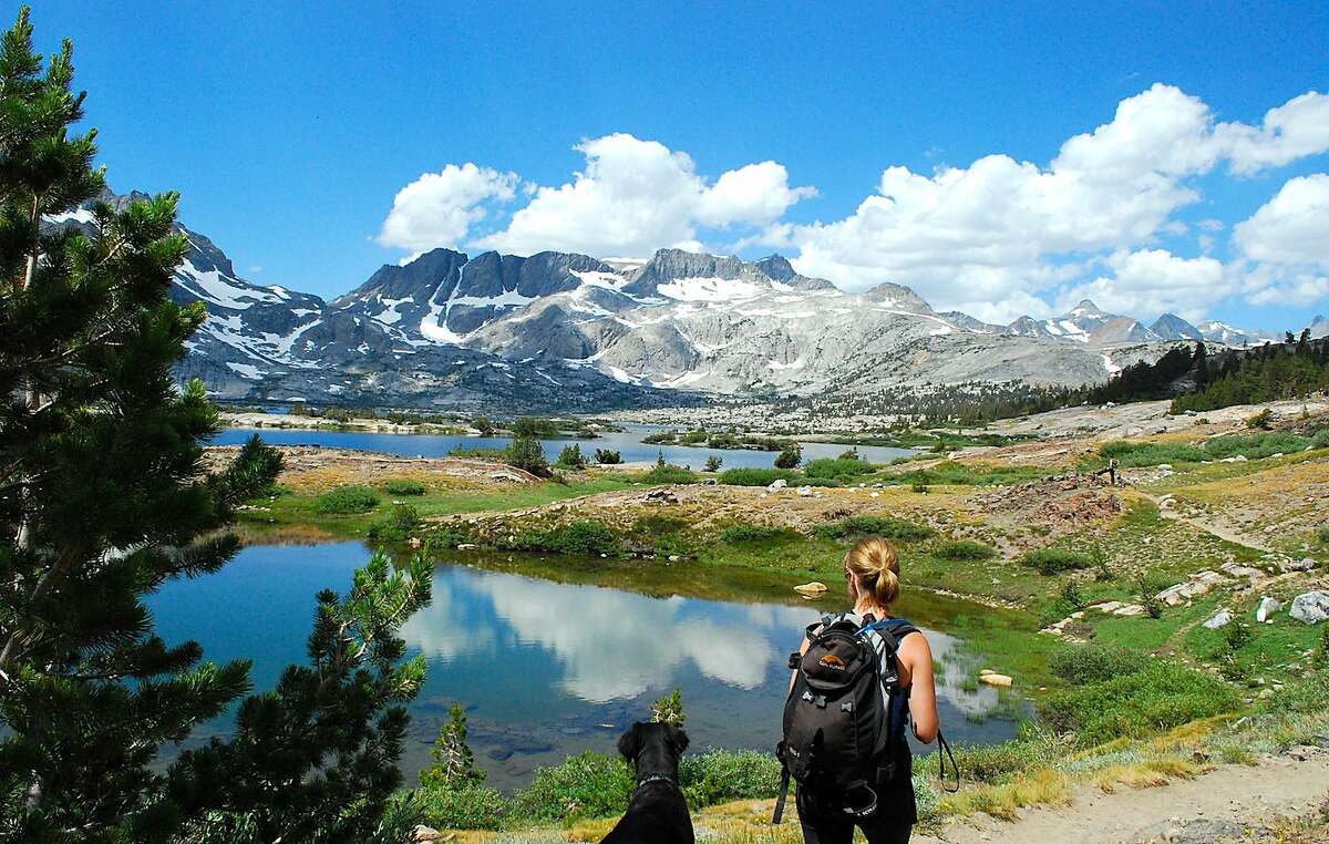 From the foot of Thousand Island Lake, Leslie O'Berry, with her dog, Turtle, takes in the view of the Minaret Range in the Ansel Adams Wilderness out of Red's Meadows near Mammoth Lakes