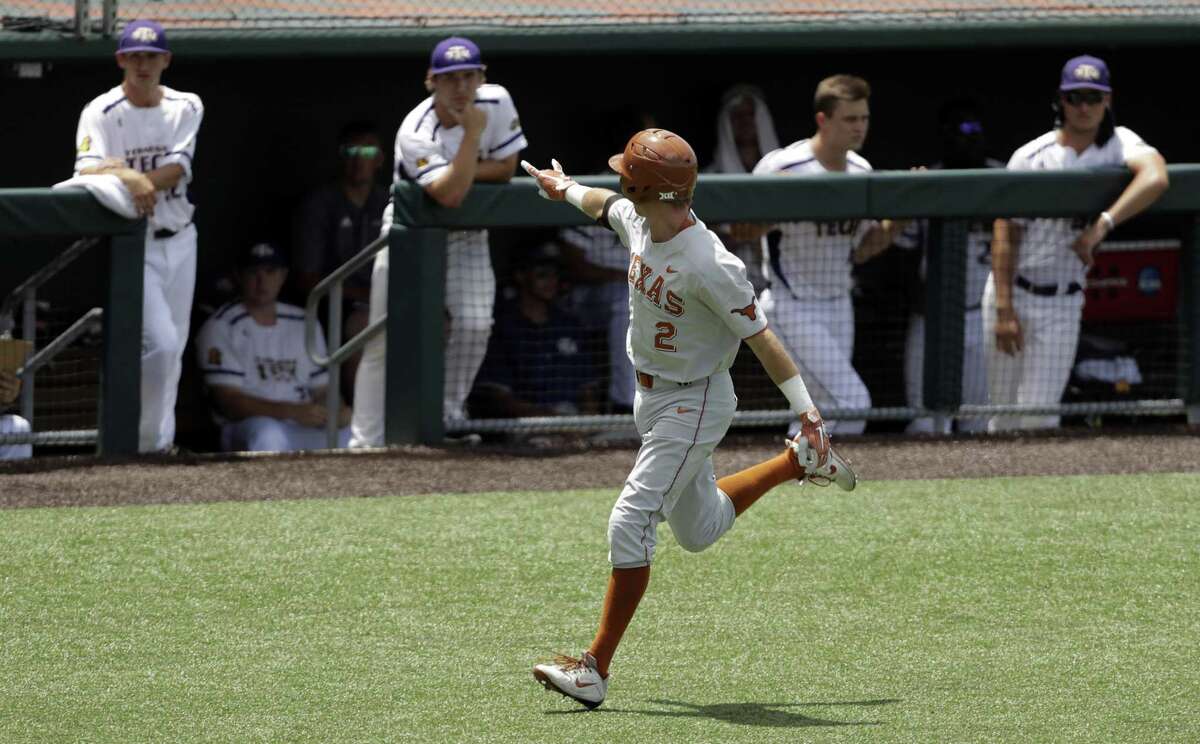 Texas slugger Kody Clemens flashes a hook ’em sign at the Tennessee Tech dugout during his home run trot on Sunday.