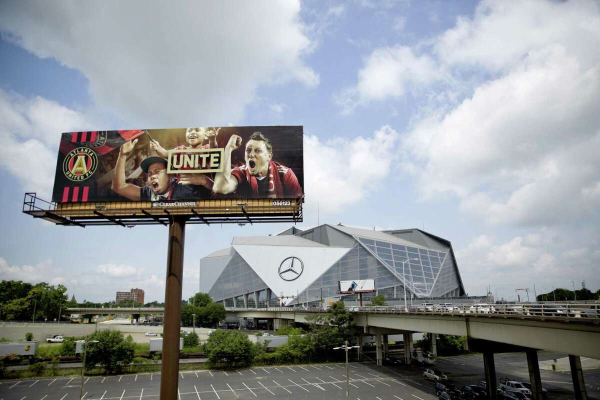A billboard for Atlanta's MLS soccer team stands next to Mercedes-Benz Stadium where the team plays in Atlanta, Wednesday, June 13, 2018. The 2026 World Cup will return to the U.S. for the first time since 1994. (AP Photo/David Goldman)