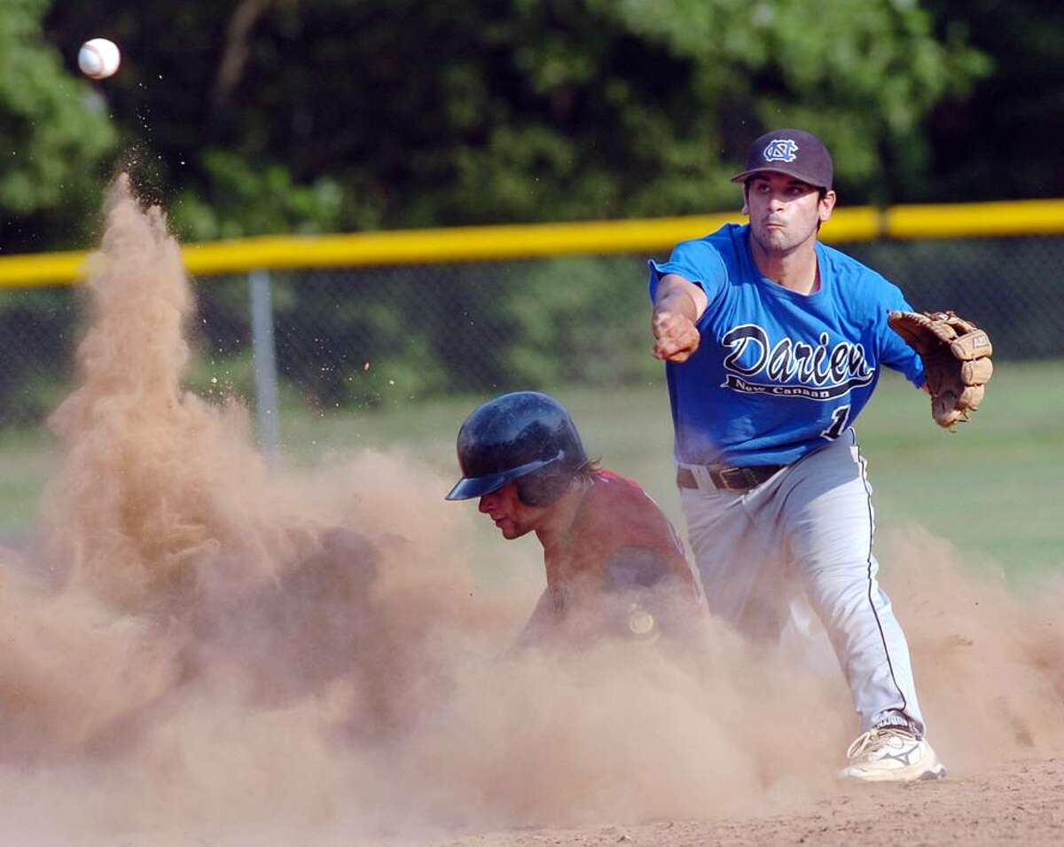 Greg Bayliss of the Greenwich Cannons (in the dirt) is unable to break-up a double play as Chris Bruno of the Darien American Legion team relays the throw to first for the double play during top of the second inning of game at Mead Park, New Canaan, July 6, 2010. Darien won the game 5-3.