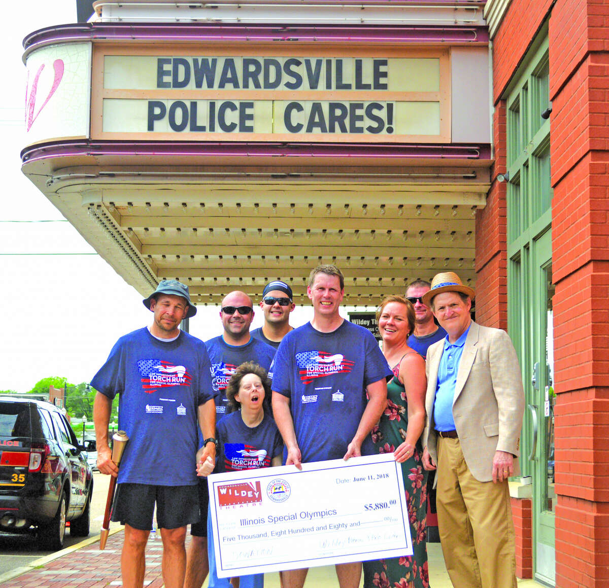 The Wildey Theater made a check presentation for $5,880 for Special Olympics to the Edwardsville Police Department on Monday afternoon during the Special Olympics Torch Run. From left to right are Edwardsville police officers Justin Towell and Mark Lask, Special Olympics athlete Lisa Newbury, Edwardsville police officers Jackson Nolan and Mike Fillback, Wildey Theater assistant manager Janel Ellsworth, Edwardsville police dispatcher James Henghold and Wildey Theatre manager Al Canal.