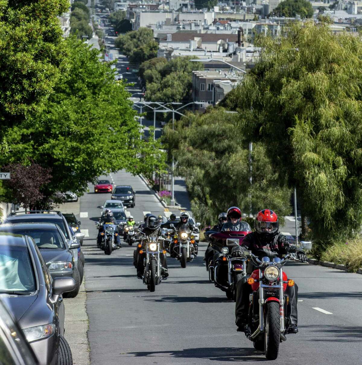 Members of the Dykes on Bikes ride up Guerrero Street in San Francisco on May 28 during a memorial ride for Soni Wolf.